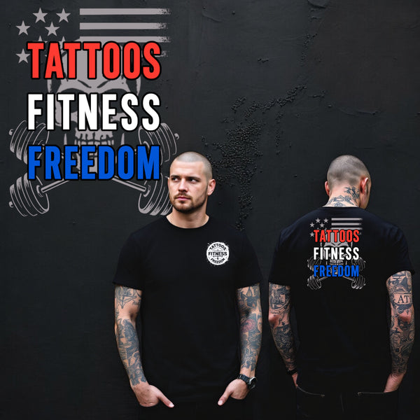Model wearing a black t-shirt featuring 'Tattoos Fitness Freedom' on the back and an emblem on the front.