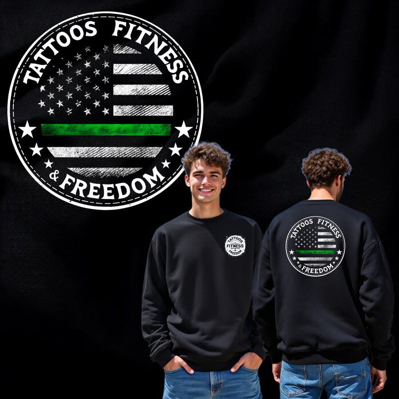 Man wearing a black sweatshirt featuring a green line and 'Tattoos Fitness & Freedom' graphic on the front and back.